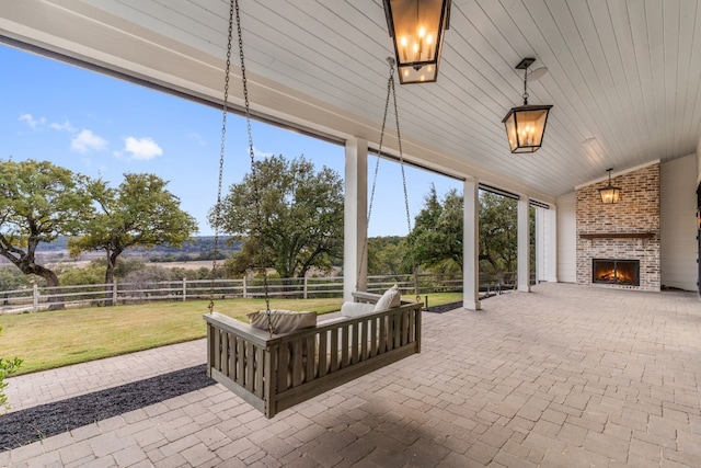 view of patio with a fenced backyard and an outdoor brick fireplace