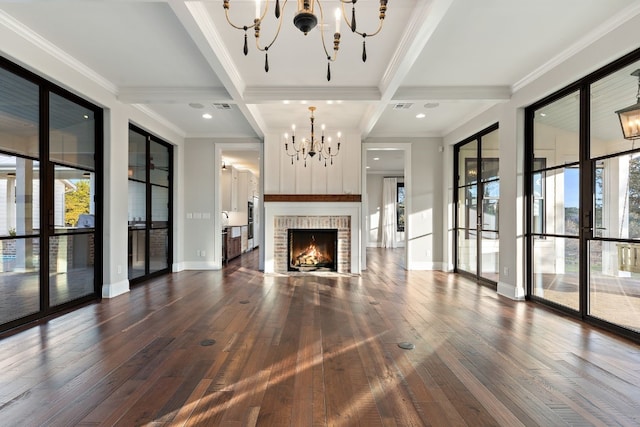 unfurnished living room featuring visible vents, dark wood finished floors, an inviting chandelier, ornamental molding, and beamed ceiling