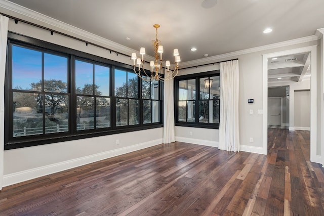 unfurnished dining area with wood finished floors, recessed lighting, crown molding, baseboards, and a chandelier