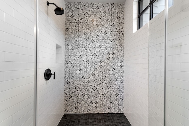 full bath with a tile shower