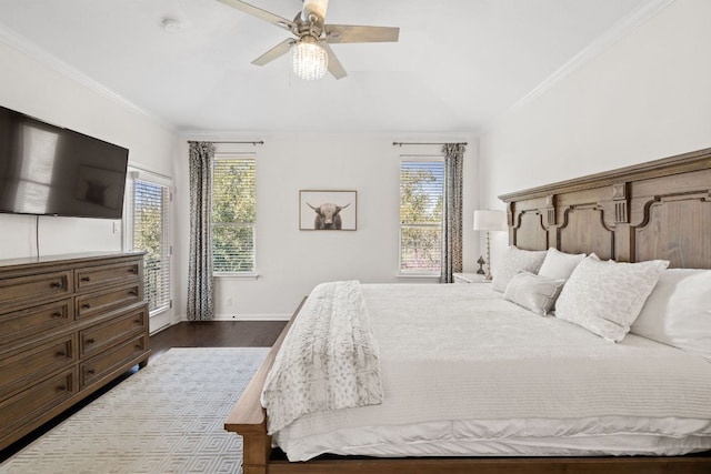 bedroom with dark wood-style floors, multiple windows, and crown molding