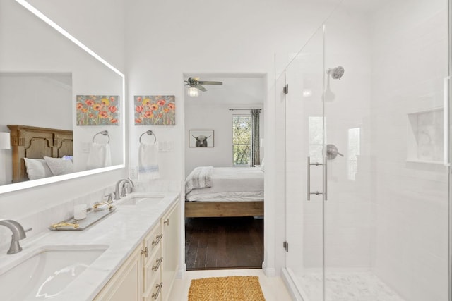 ensuite bathroom featuring a sink, a shower stall, and connected bathroom