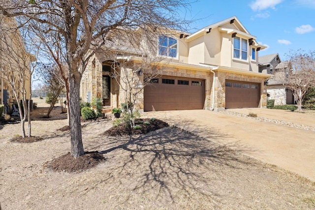 view of front of home with stone siding, stucco siding, driveway, and an attached garage