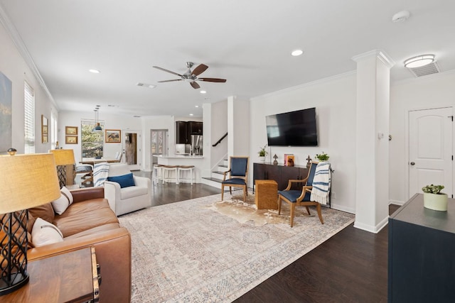 living room with a ceiling fan, recessed lighting, dark wood-style flooring, stairs, and crown molding