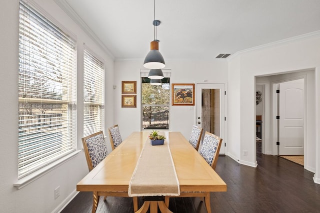 dining area with visible vents, baseboards, dark wood-style floors, and crown molding