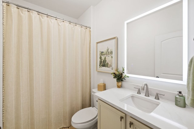 bathroom featuring toilet and vanity