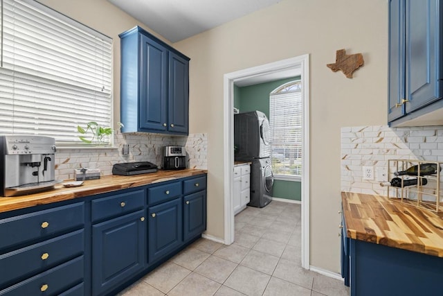 kitchen featuring butcher block countertops and blue cabinets