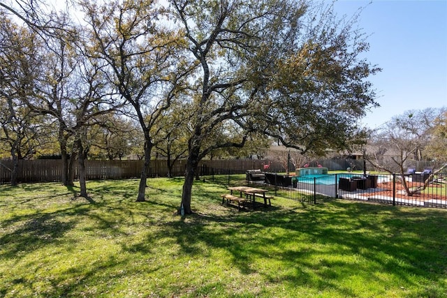 view of yard with a fenced in pool and a fenced backyard