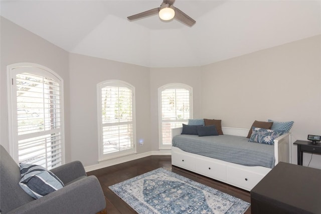 bedroom featuring multiple windows, wood finished floors, and vaulted ceiling