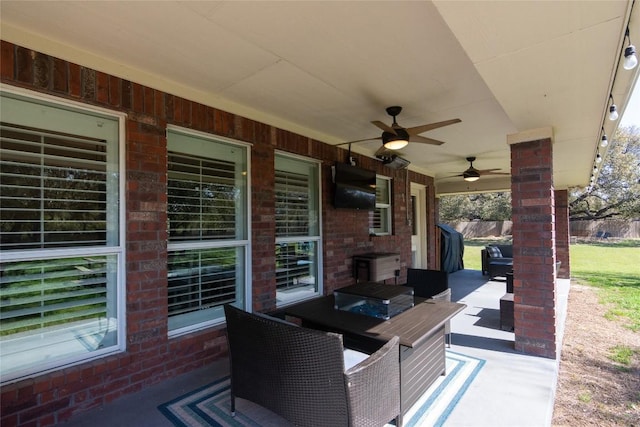 view of patio featuring outdoor lounge area, a ceiling fan, and fence