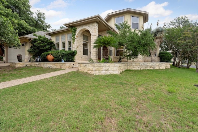 view of front facade featuring a front yard, a garage, and stucco siding