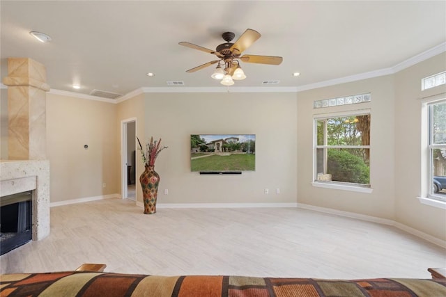 unfurnished living room with baseboards, a high end fireplace, and ornamental molding