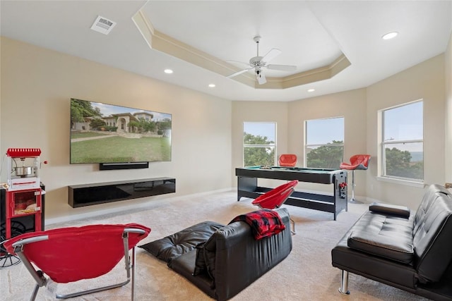 carpeted living area with a wealth of natural light, visible vents, recessed lighting, and a raised ceiling