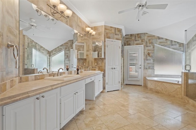 bathroom featuring vaulted ceiling, a garden tub, ceiling fan, and a sink