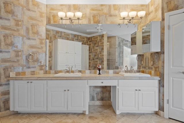 bathroom with double vanity, a sink, a ceiling fan, and ornamental molding