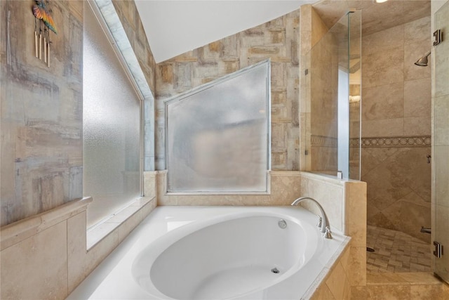 bathroom featuring a stall shower and a garden tub