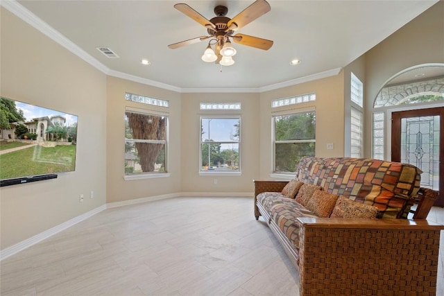 living area featuring ceiling fan, visible vents, baseboards, and ornamental molding