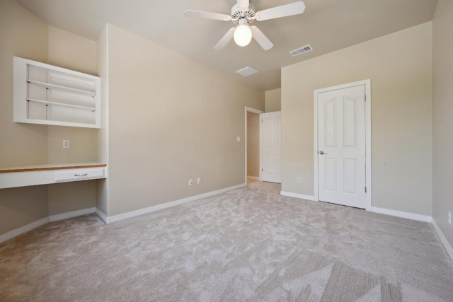 9907 Spicewood Mesa, Austin, TX 78759 - unfurnished bedroom featuring built in study area, carpet, and ceiling fan