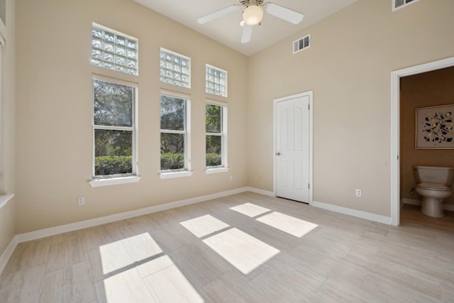 9907 Spicewood Mesa, Austin, TX 78759 - unfurnished bedroom with a towering ceiling, ensuite bath, and a ceiling fan