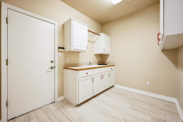 9907 Spicewood Mesa, Austin, TX 78759 - laundry room with a sink and baseboards