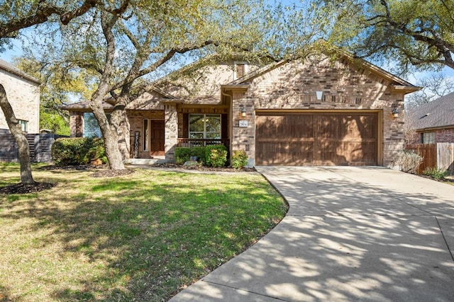 view of front facade with a front lawn, fence, concrete driveway, a garage, and stone siding