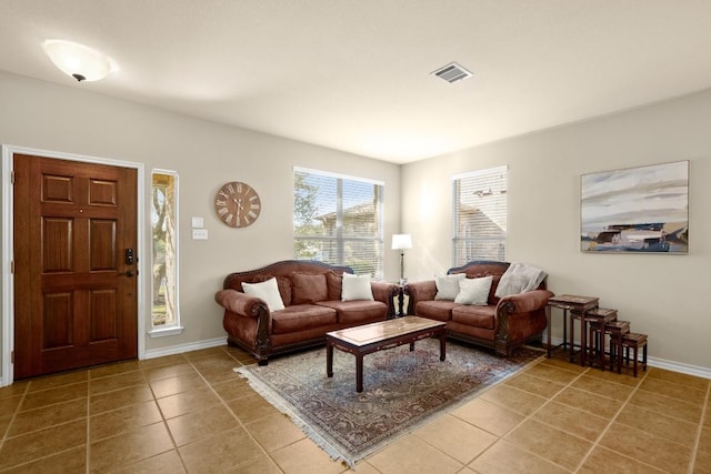 tiled living room with baseboards and visible vents