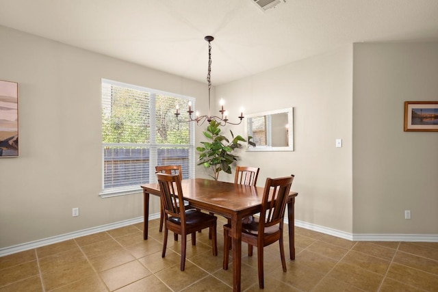 tiled dining room with a chandelier, visible vents, and baseboards