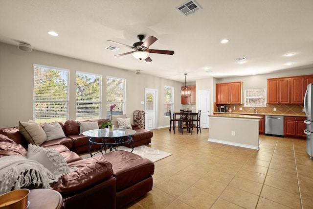 living area featuring light tile patterned floors, visible vents, recessed lighting, and a ceiling fan