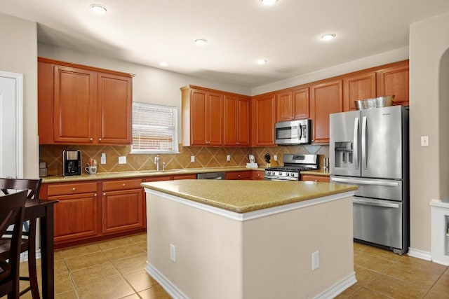 kitchen with a sink, light tile patterned floors, tasteful backsplash, and stainless steel appliances