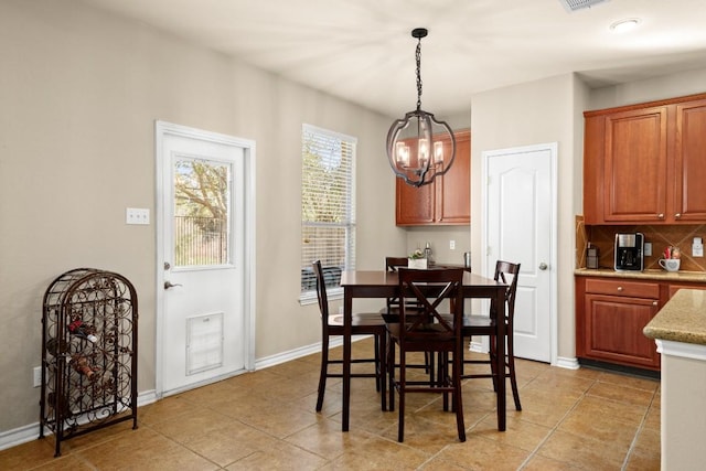 dining space with visible vents, baseboards, an inviting chandelier, and light tile patterned flooring