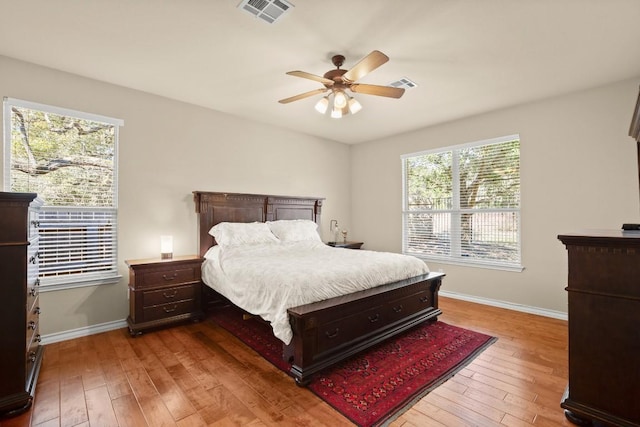 bedroom featuring visible vents, wood-type flooring, and baseboards