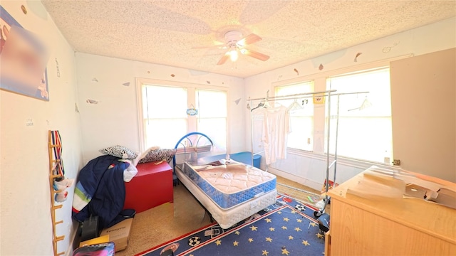 bedroom featuring ceiling fan and a textured ceiling