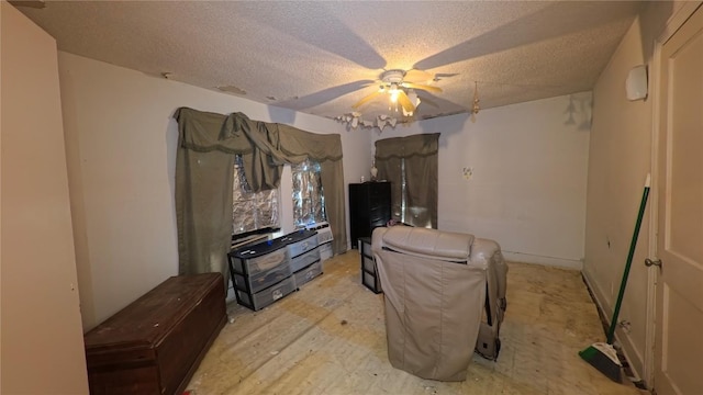 living area with a textured ceiling and a ceiling fan