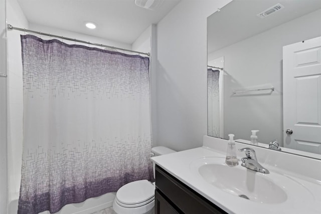 bathroom featuring vanity, shower / tub combo, toilet, and visible vents