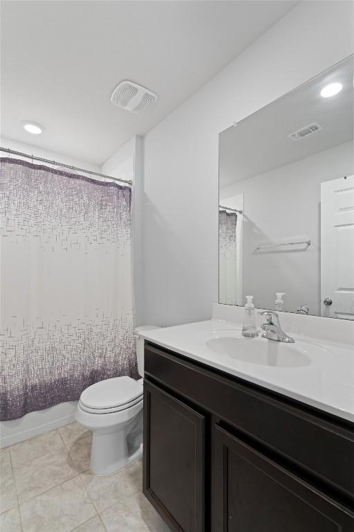 full bathroom with tile patterned flooring, visible vents, toilet, and vanity