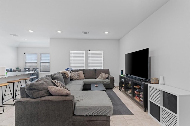 living area with light tile patterned floors, visible vents, and recessed lighting