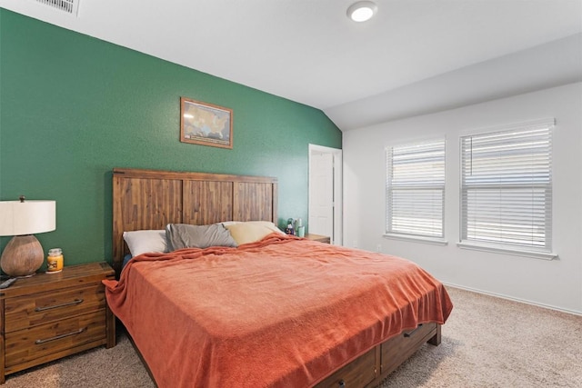 bedroom featuring visible vents, carpet, and vaulted ceiling