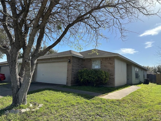 3015 Caleb Dr, Austin, TX 78725 - view of property exterior featuring brick siding, an attached garage, central AC unit, and driveway