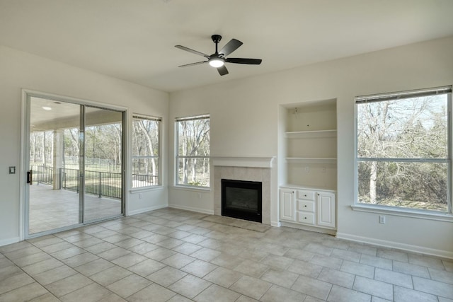 113 Yaupon Ln, Georgetown, TX 78633 - unfurnished living room with a ceiling fan, baseboards, a tile fireplace, and built in features