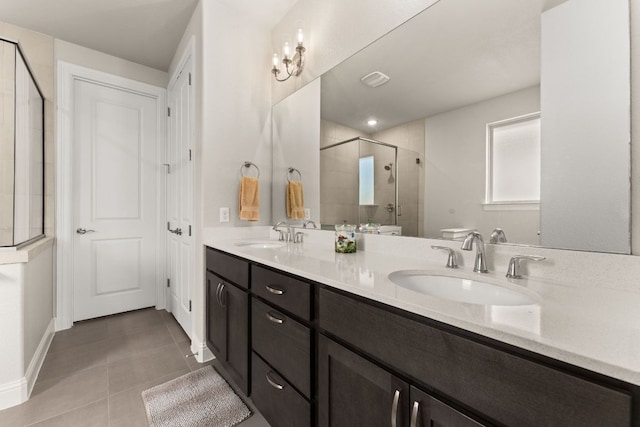 full bath featuring tile patterned flooring, a stall shower, double vanity, and a sink