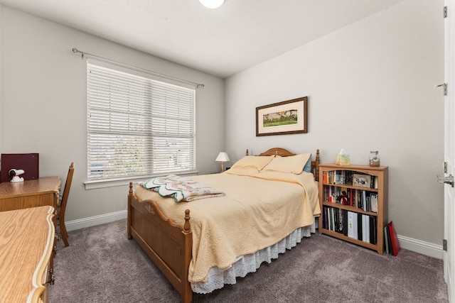 bedroom featuring baseboards and carpet