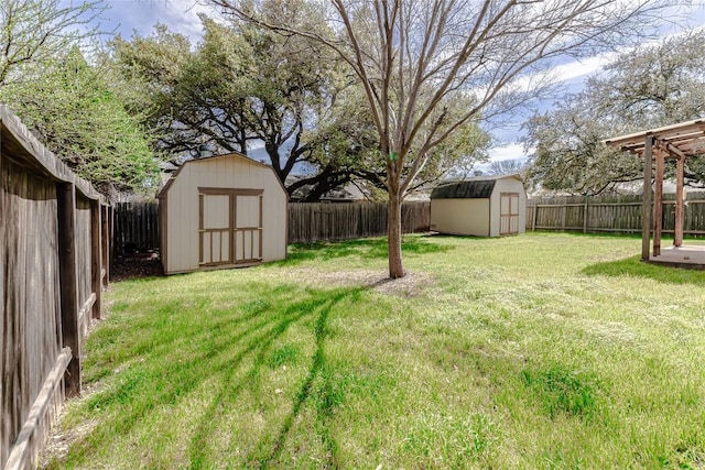 view of yard featuring an outbuilding, a storage unit, and a fenced backyard