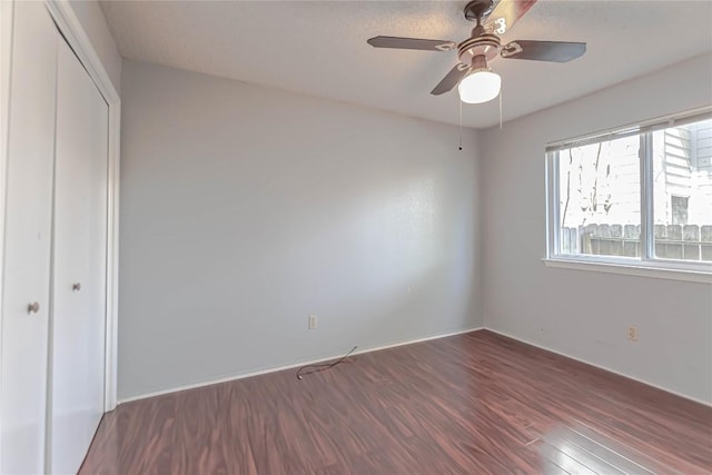 unfurnished bedroom featuring a closet, a ceiling fan, and wood finished floors