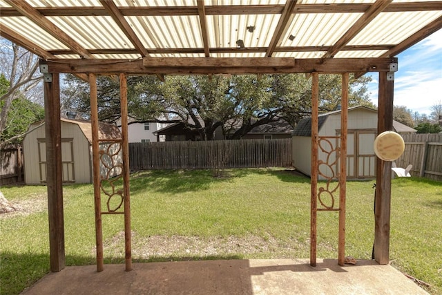 view of yard with an outbuilding, a storage unit, and a fenced backyard