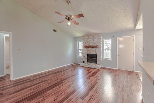 unfurnished living room with visible vents, a textured ceiling, light wood-style flooring, and a ceiling fan