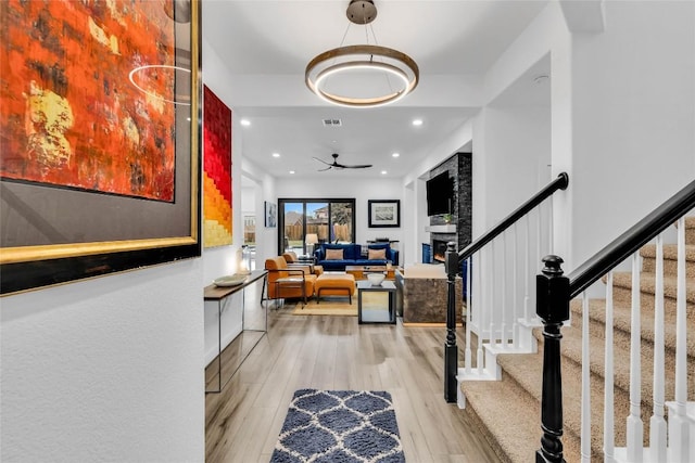 foyer entrance featuring stairs, light wood-style flooring, recessed lighting, and a ceiling fan