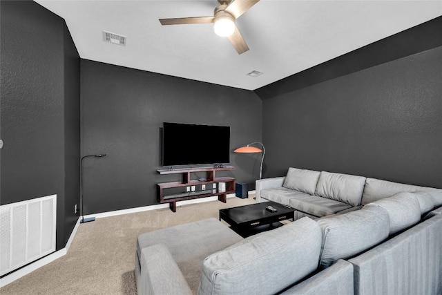 living area featuring carpet flooring, visible vents, and a ceiling fan