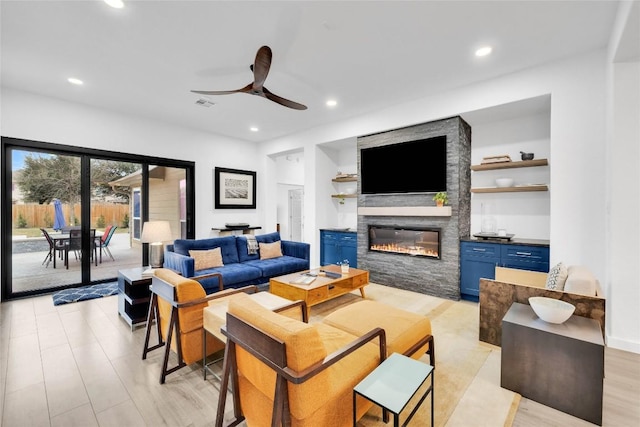 living area featuring recessed lighting, a fireplace, visible vents, and ceiling fan