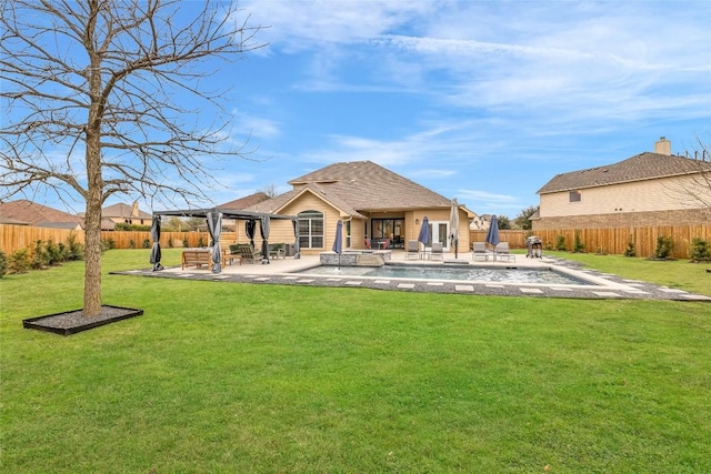 back of house with a yard, a patio area, and a fenced backyard