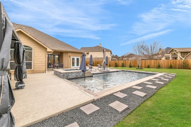 view of pool with a patio area, a yard, french doors, and a fenced backyard